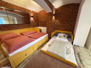a bedroom with a bed and a brick wall at Boho & Loft 2 Zimmer Parkplatz in Bad Hersfeld
