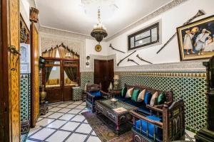 a living room with a couch and a table at Spacious Apartment in Fès with Private Pool, 150 sqm in Fez