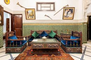 a living room with chairs and a coffee table at Spacious Apartment in Fès with Private Pool, 150 sqm in Fez