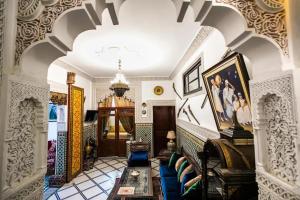 a living room with a couch and a table at Spacious Apartment in Fès with Private Pool, 150 sqm in Fez +28 photos