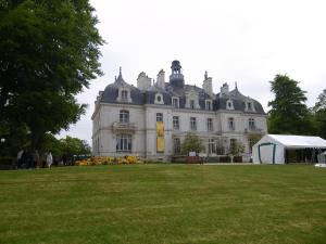 a large white house with a tent in front of it at Le Briantais in Saint Malo