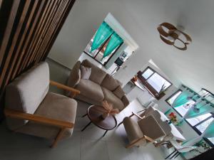 a living room with two chairs and a couch at Cap'vanille in Saint-Philippe