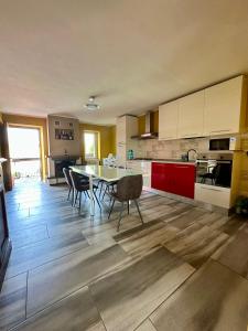 a large kitchen with a table and chairs in it at B&B LA CORTE in Puegnano del Garda