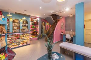 a shop with pink and blue walls and a staircase at Hotel Chromatic in Guatapé