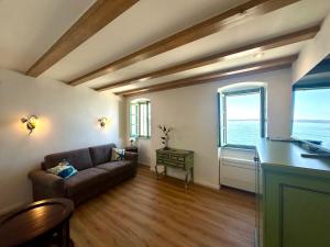 a living room with a couch and a table at Casa Valentina in Piran