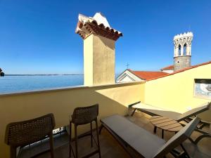a balcony with chairs and a view of the water at Casa Valentina in Piran