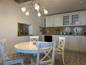 a kitchen with a dining room table and chairs at Casa Valentina in Piran