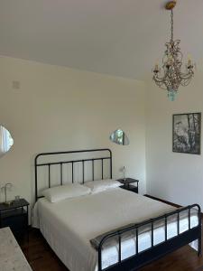a bedroom with a bed and a chandelier at Brezza sul Colle in Montesilvano