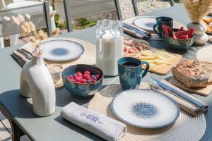 a table with plates of food on a table at Villa Belvedere by Comorooms in Como