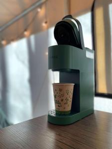 a coffee machine sitting on a table with a cup at The Goldfinch's Nest - Glamping Tent with AC in Rogers