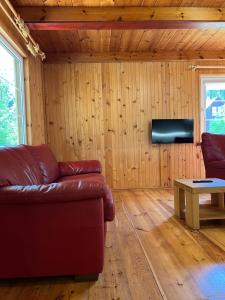a living room with a couch and a table at Domki Pod Lasem in Macharce