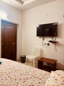 a hotel room with a bed and a tv on the wall at Sunrise beach resort perupalem in Perupalem +24 photos