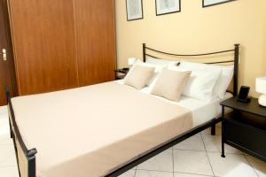 a bedroom with a bed with white sheets and pillows at Lovely Fiuggi Apartment - near the Thermal Baths in Fiuggi