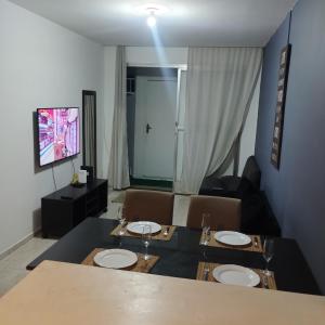 a dining room with a table and a couch at Cobertura posto 5 in Rio de Janeiro