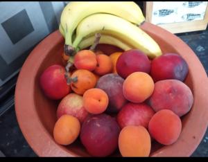 a bowl of fruit with bananas and apples and oranges at Casa da Teresa Lisboa in Lisbon +13 photos