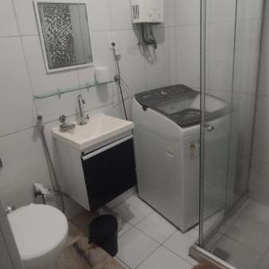 a bathroom with a shower and a toilet and a sink at Cobertura posto 5 in Rio de Janeiro +14 photos