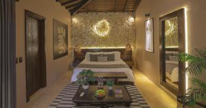 a bedroom with a bed and a table in it at Hotel Casa Candela in San Jerónimo