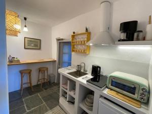 a kitchen with a sink and a microwave on a counter at Lagadi House 2 in Arnados