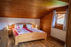 a bedroom with a bed in a wooden room at Ferienwohnung Schoberhof in Filzmoos