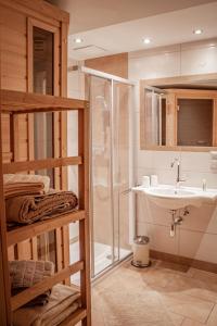 a bathroom with a shower and a sink at Ferienwohnung Schoberhof in Filzmoos