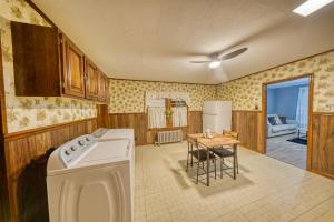 a kitchen with a washing machine and a table at 1-Bedroom, 1-Bath Getaway in Carbondale