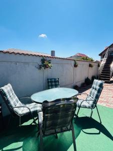a table and chairs sitting on a patio at Deacu's Home in Cumpăna +10 photos