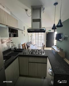 a kitchen with a stove and a counter top at Alojamiento Familiar para 40 - Con 4 Piscinas - 3 Jacuzzi - Sauna - By Molca Travel in Armenia