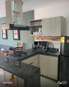 a kitchen with a stove and a counter top at Alojamiento Familiar para 40 - Con 4 Piscinas - 3 Jacuzzi - Sauna - By Molca Travel in Armenia