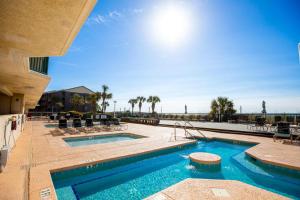 a swimming pool in a resort with chairs and a pool at Ashworth 1709 in North Myrtle Beach