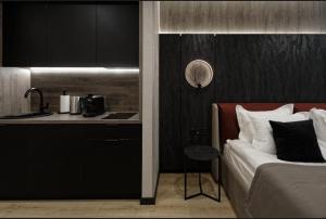 a hotel room with a bed and a kitchen at Преміальні апартаменти на березі озера Молодості in Bukovel