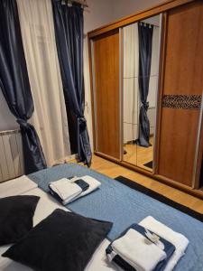 a bedroom with a bed with towels and a mirror at The One in Baška Voda