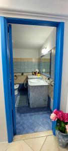 a bathroom with a tub and a sink and a toilet at Casa Vacanze Laura in Tortolì