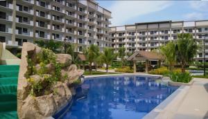 a swimming pool in front of a building at Mysuites2go 517 Lenden in Manila