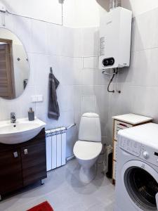 a bathroom with a toilet and a sink and a washing machine at 10 min to Old Town - Free Parking - Work Station in Tallinn