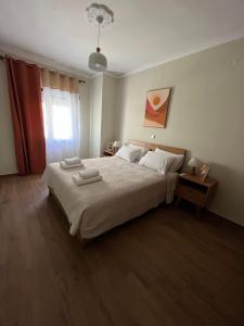 a bedroom with a large bed and a window at Kountouriotou 24 hospitality in Chios