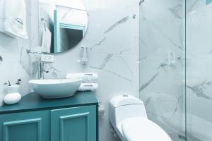 a bathroom with a sink and a mirror at Hotel Chromatic in Guatapé +62 photos