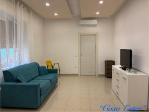 a living room with a blue couch and a tv at Casa Ester e Antonella in Maiori