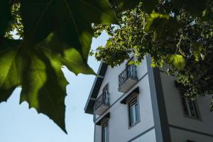 a white building with two balconies on it at Live Sintra Boutique Guest House in Sintra