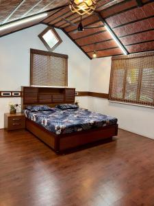 a bedroom with a large bed in a room at Wood House Near Isha And Karunya University by Shivalaya in Alāndurai