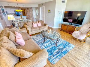a living room with a couch and a table at Ashworth 903 in North Myrtle Beach