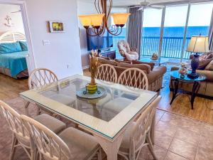 a dining room and living room with a table and chairs at Ashworth 903 in North Myrtle Beach