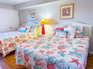 a bedroom with two beds and a lamp at Ashworth 903 in North Myrtle Beach +30 photos