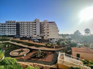 a large building with a clock in front of it at ESTUDIO DEBORA in Playa Fañabe