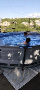 a man is in a swimming pool in at Shushan GUEST HOUSE in Yeghegnadzor