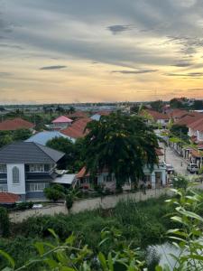 a town with houses and a tree in the foreground at Honey in Ban Bang Khan