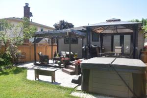 a backyard with a hot tub and a gazebo at Cozy Suite with HOT TUB & Highspeed Internet in Grimsby