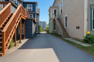 a walkway between two buildings next to a building at Elegant Escape, Modern Luxe in Historic Suite in Saint John