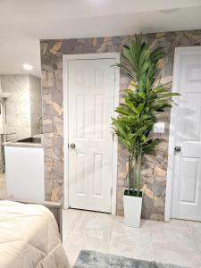 a bedroom with a white door and a plant at Vessel Hotel Studio Suites of Atlanta, GA in Atlanta