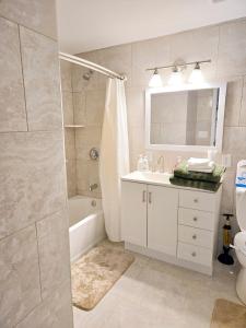 a bathroom with a tub and a sink and a toilet at Vessel Hotel Studio Suites of Atlanta, GA in Atlanta