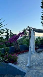 a pavilion with a white canopy and some flowers at Edem House - Volos Greece in Volos